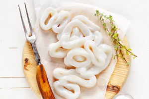 sliced raw squid rings with lime, olive oil, breadcrumbs. Preparation of  Summer  healthy snacks
